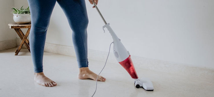a person vacuuming the floor 