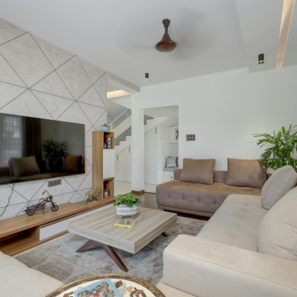 Modern living room with clean sofas, geometric wall design, and bright natural light — representing professional living area deep cleaning in San Diego.