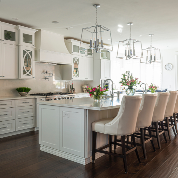 Bright white kitchen with marble countertops, fresh flowers, and clean surfaces — showcasing professional kitchen deep cleaning in San Diego.