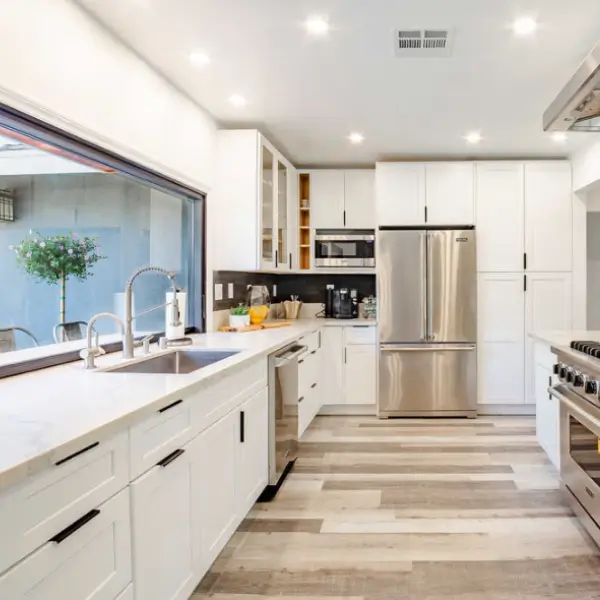 A spotless modern white kitchen professionally cleaned as part of move-in and move-out cleaning services in San Diego.