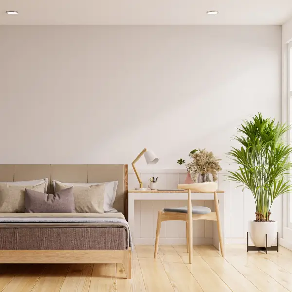 Minimalist bedroom with soft lighting, wooden floor, and fresh linens — symbolizing standard bedroom cleaning in San Diego homes.