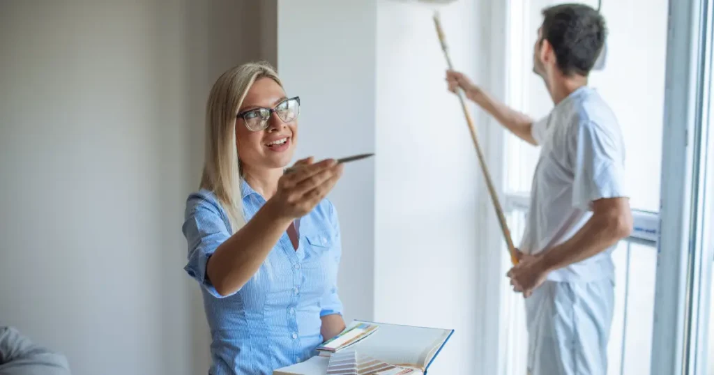 Property manager reviewing a freshly cleaned rental home with a professional cleaner preparing the space for tenants