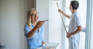 Property manager reviewing a freshly cleaned rental home with a professional cleaner preparing the space for tenants