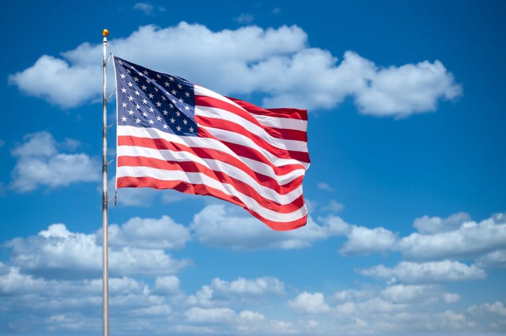 American flag flying against a blue sky